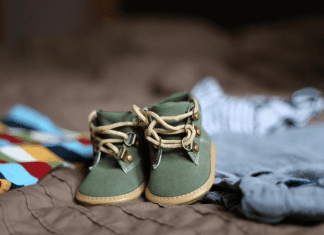a pair of sage green baby shoes. decorative image