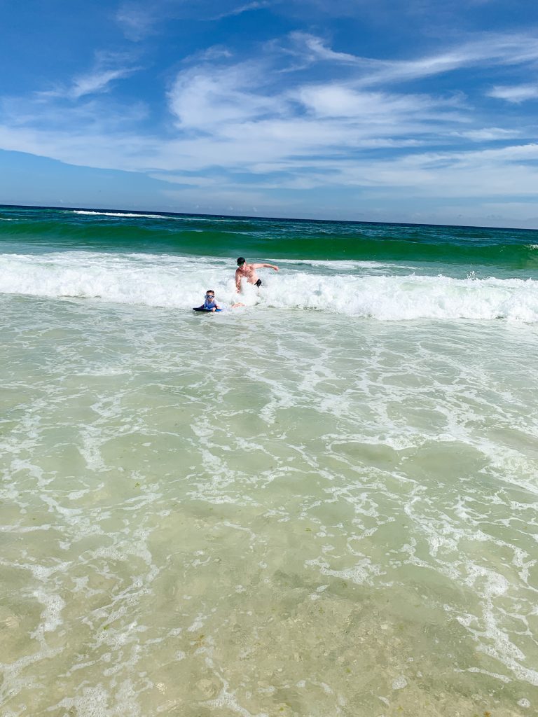 a father and son body surfing in the Gulf of Mexico