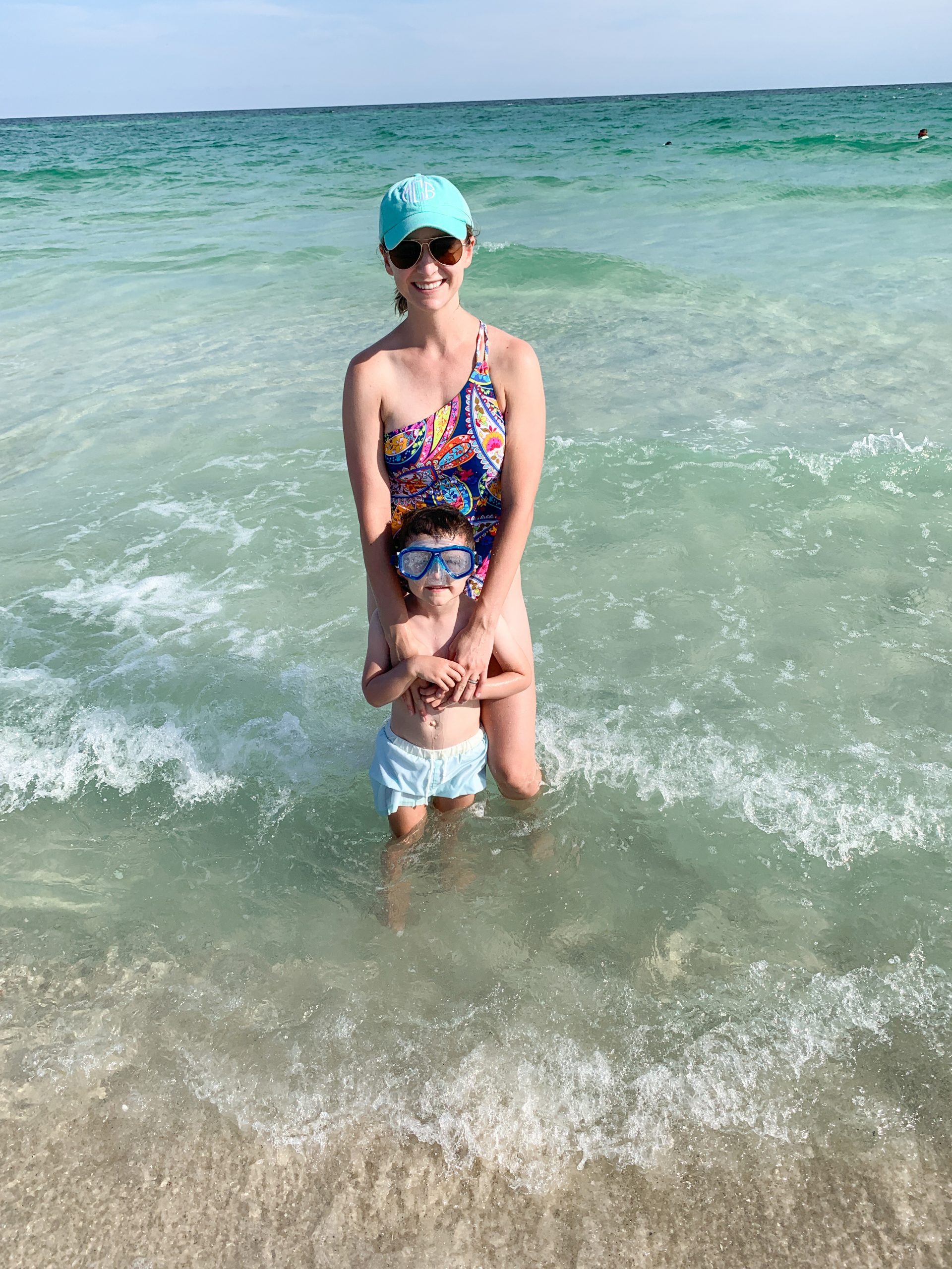 Mom and son standing knee-deep in the waters of the Gulf of Mexico