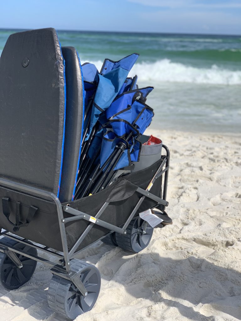 a beach wagon filled with beach chairs and boogie boards