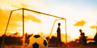 soccer ball and goal at sunset