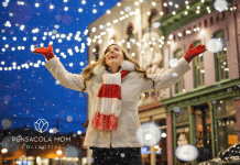 woman enjoying Christmas lights downtown