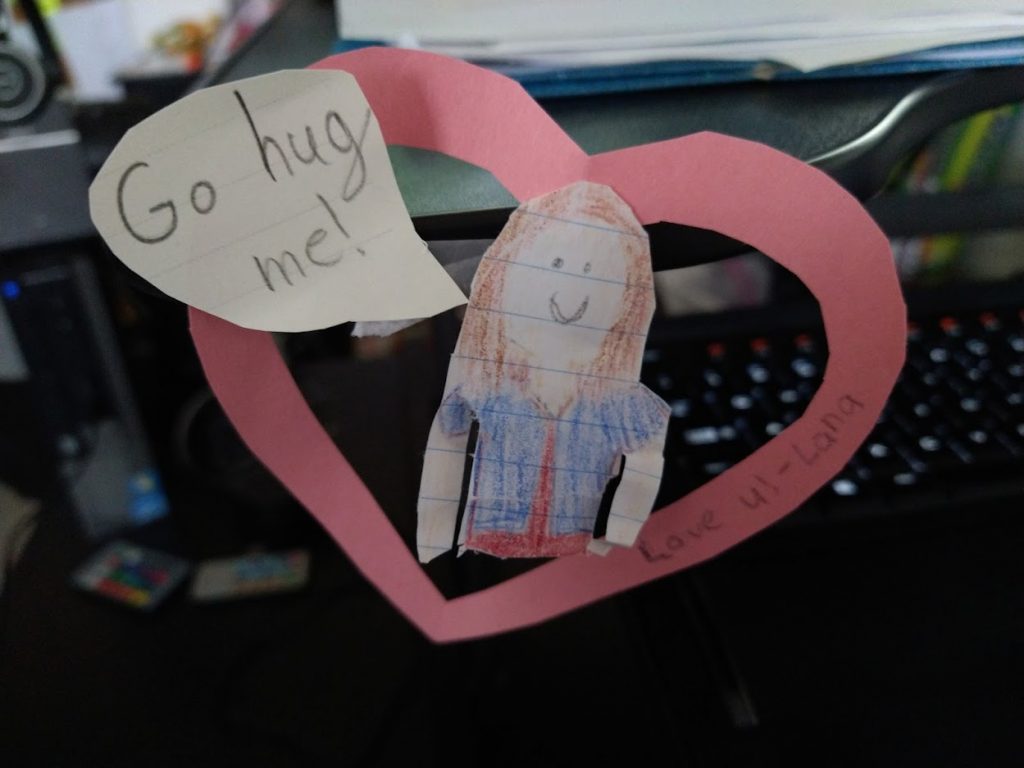 Being a more affectionate partner and parent. A hand drawn little girl inside a heart telling me to hug her. 
