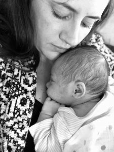 Losing the weight; a mother snuggling her newborn