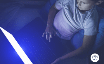 Young boy on laptop in the dark