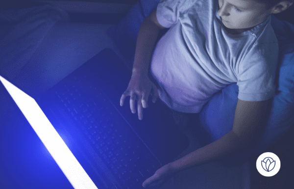 Young boy on laptop in the dark