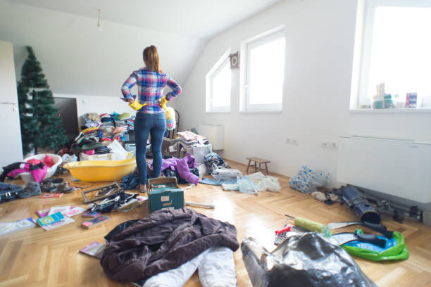 Woman staring at a pile of clutter to be organized