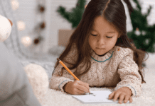 Young girl writing a letter