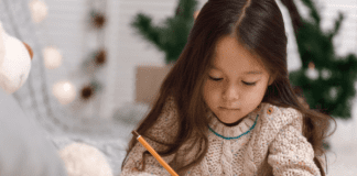 Young girl writing a letter