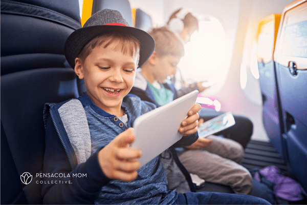 Child watching tablet on plane