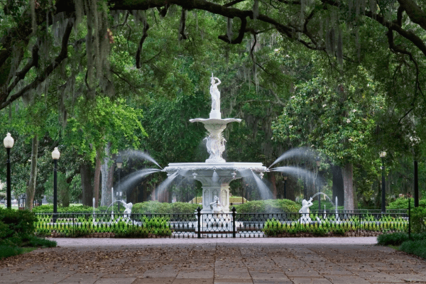 a marble water fountain and statue in Forsyth Park in Savannah, Georgia. 