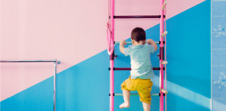 A small child climbing a ladder