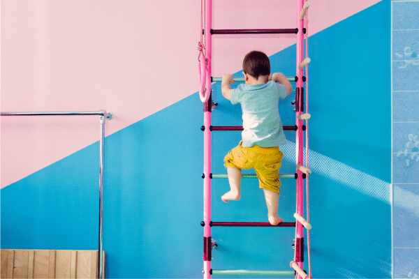 A small child climbing a ladder