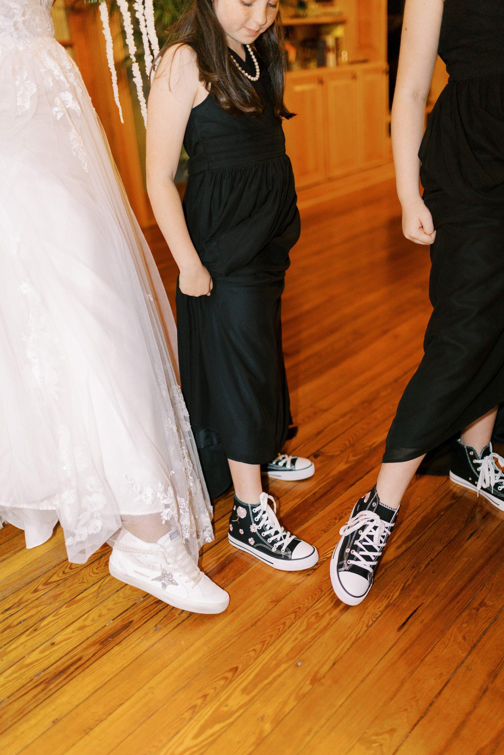 Bride Robin and her daughters show off their Converse sneakers under their dresses.