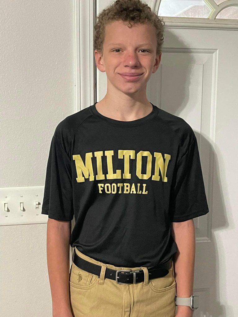 a 14 year old boy wearing a Milton Football t-shirt