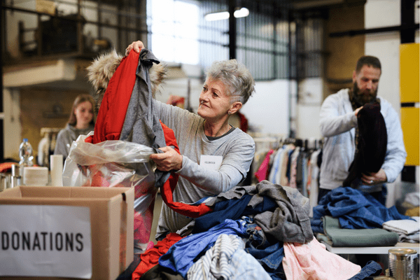 volunteers sorting through clothing donations