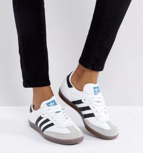 a pair of white Adidas sneakers with black stripes
