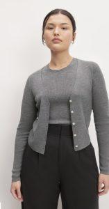 a woman earring a grey cardigan with black pants
