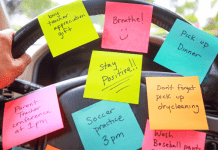 A steering wheel of a car with 8 different post-it notes listing various errands and things for a mom to remember.