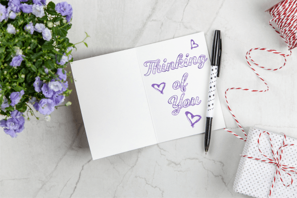 A greeting card with "thinking of you" written on it.